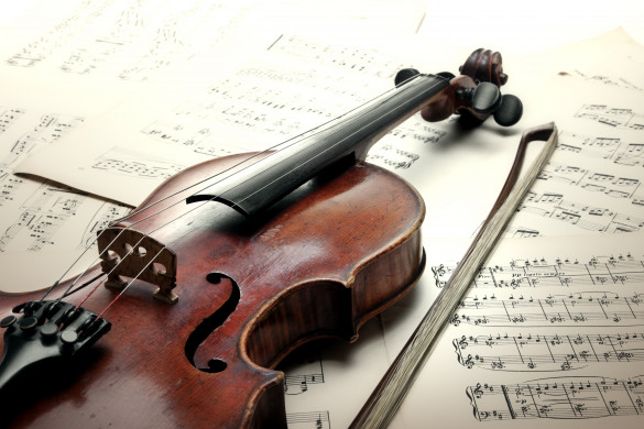 Old scratched violin with sheet music
