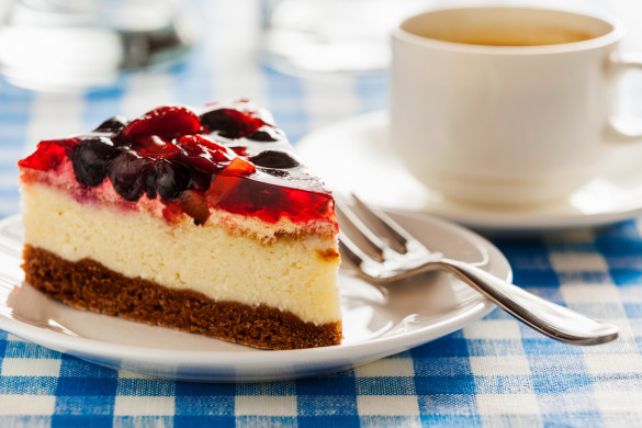 Cake on plate with fork and coffee cup