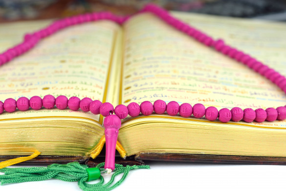 Holy Koran with a rosary praying beads