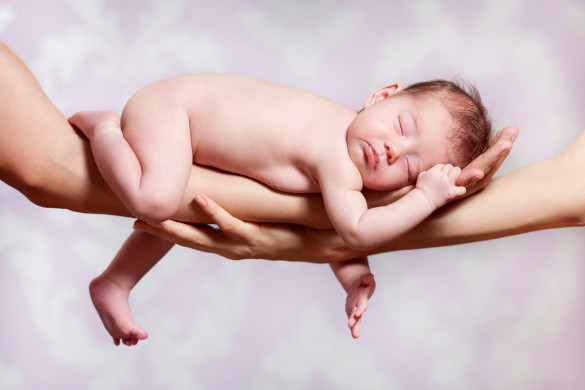 Newborn baby sleeping on parents hands, relax