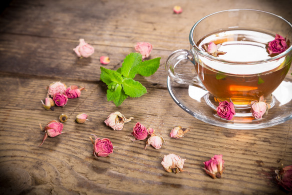 Cup of green tea with mint and dried roses