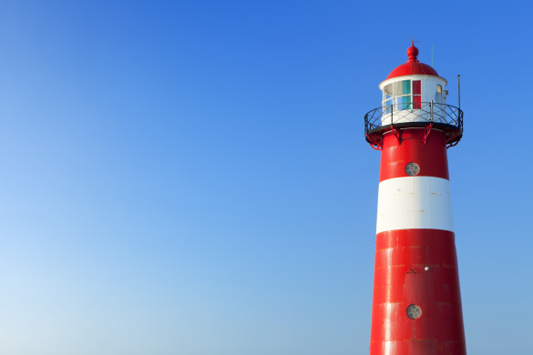 Red and white lighthouse and a clear blue sky