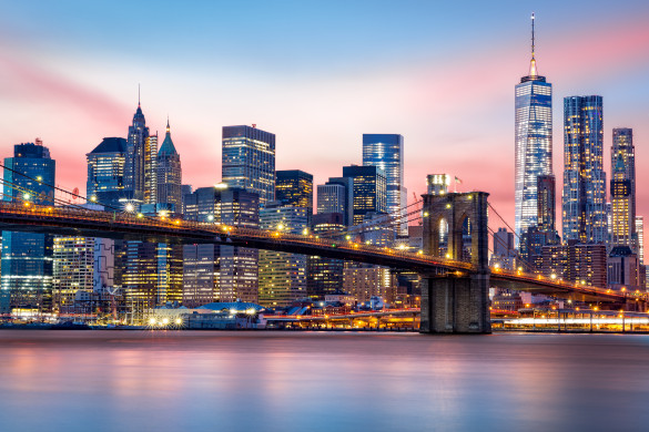 Manhattan skyline under a purple sunset