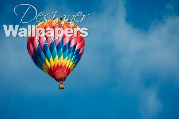 Brightly colored hot air balloon with a sky blue background