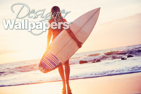 Surfer girl on the beach at sunset