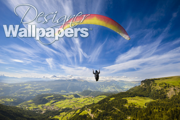Paraglider flying over mountains