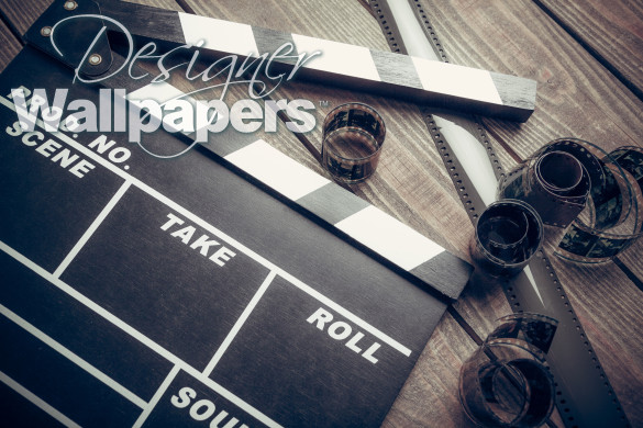 Film. Movie clapper and film reel on a wooden background