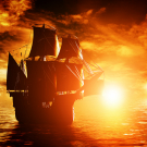 Ancient pirate ship sailing on the ocean at sunset