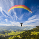 Paraglider flying over mountains