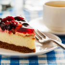 Cake on plate with fork and coffee cup