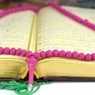 Holy Koran with a rosary praying beads