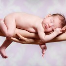 Newborn baby sleeping on parents hands, relax