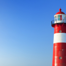 Red and white lighthouse and a clear blue sky