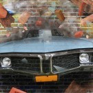 Graffiti car on a brick wall