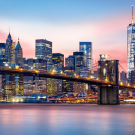 Manhattan skyline under a purple sunset