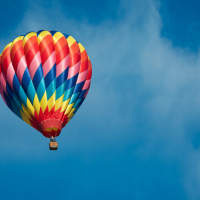 Brightly colored hot air balloon with a sky blue background