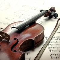 Old scratched violin with sheet music