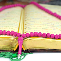 Holy Koran with a rosary praying beads