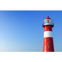 Red and white lighthouse and a clear blue sky