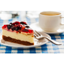 Cake on plate with fork and coffee cup