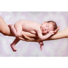 Newborn baby sleeping on parents hands, relax