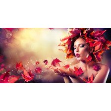 Autumn woman blowing red leaves