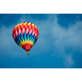 Brightly colored hot air balloon with a sky blue background