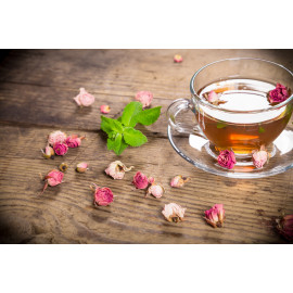 Cup of green tea with mint and dried roses
