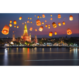 Flying paper lanterns at night