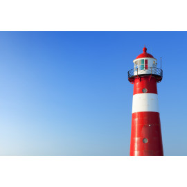 Red and white lighthouse and a clear blue sky